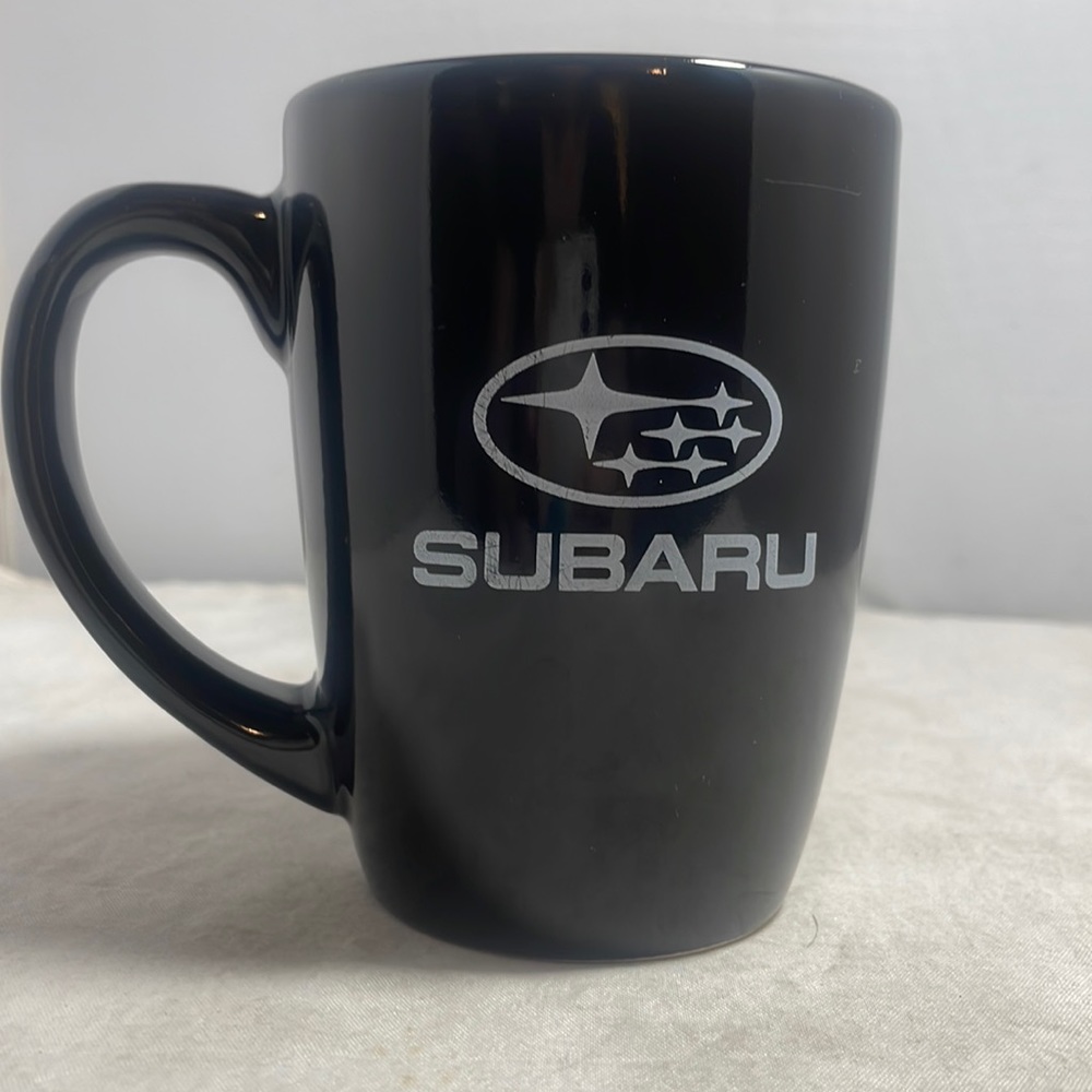 Black Subaru coffee mug with white lettering and logo